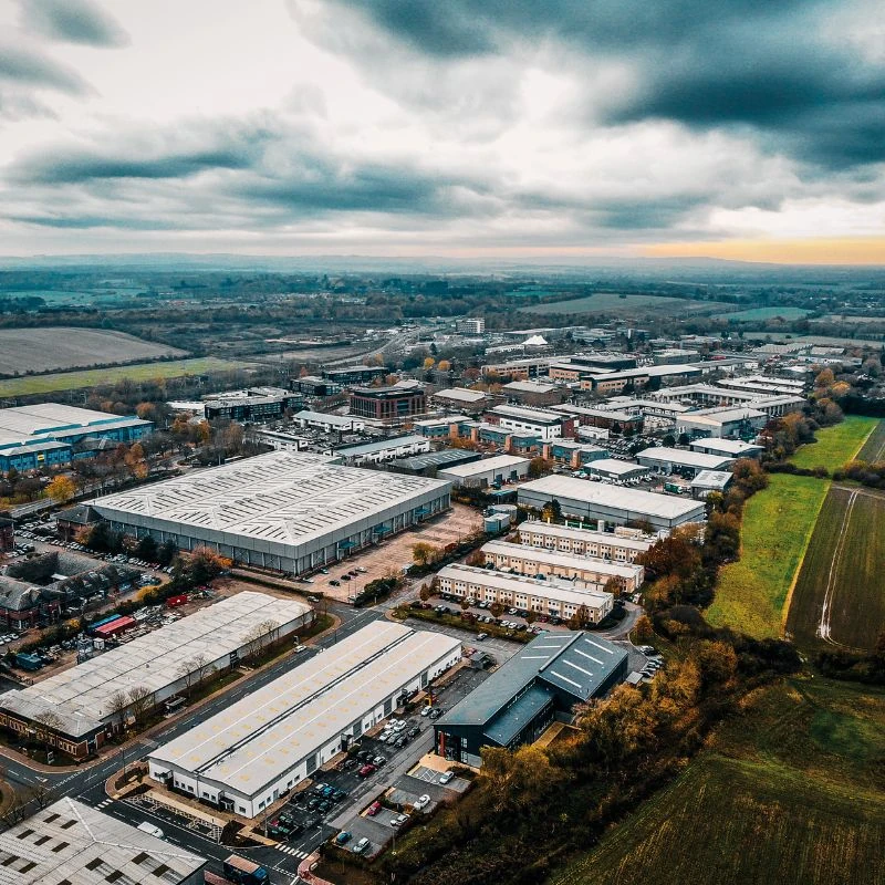 Aerial view of an industrial business park with warehouses and commercial buildings