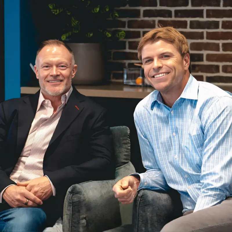 Travis Carson and Richard Schwartz seated together in a professional office setting