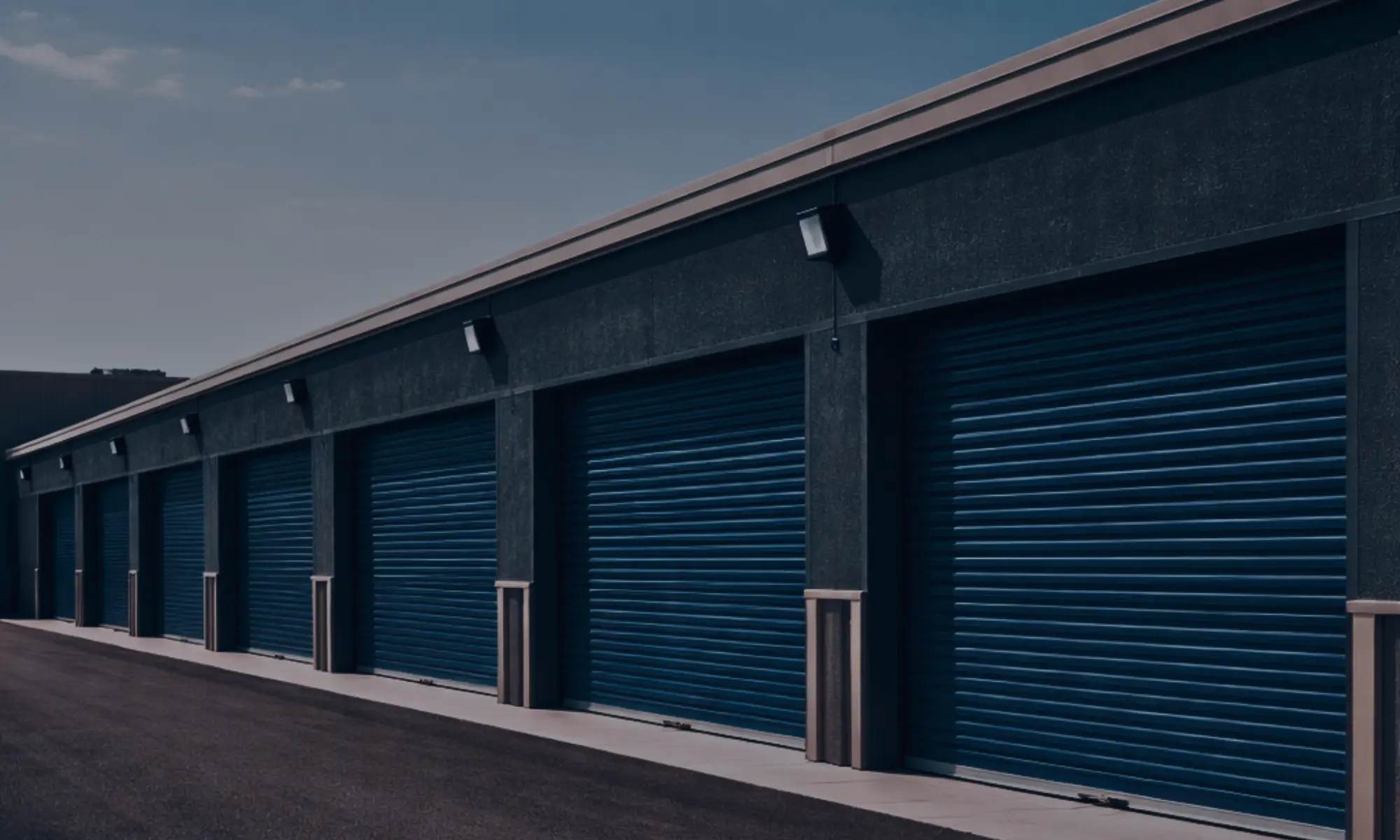 Row of self-storage units with closed roll-up doors